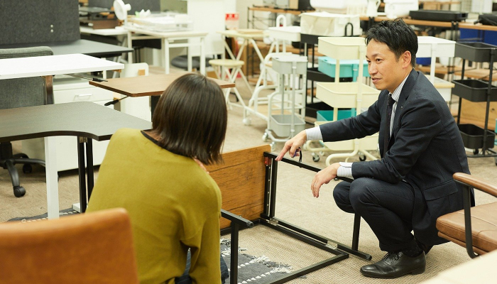 スタッフと商品の確認をする泉